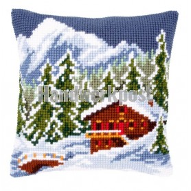 kruissteekkussen chalet in winters gebergte